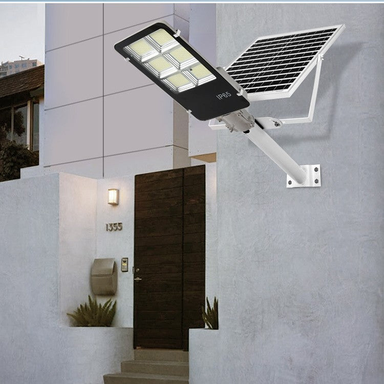 Lampa solara stradala Flippy, IP65, senzor de lumina, 100 LED-uri SMD, 7200 lm, panou 12W, putere 80W, autonomie 12-16 ore, telecomanda, montare prin fixare, pentru strada sau gradina, finisaj lucios, material ABS, 38.6 x 13.3 x 6.5 cm, lumina a-1